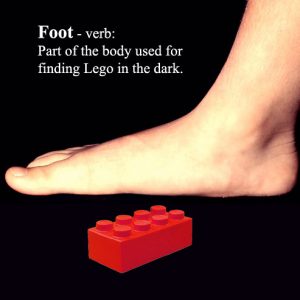 Image showing bare foot standing on lego